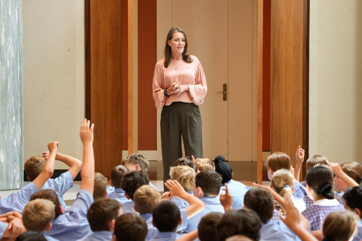 Perin Davey in front of school kids 