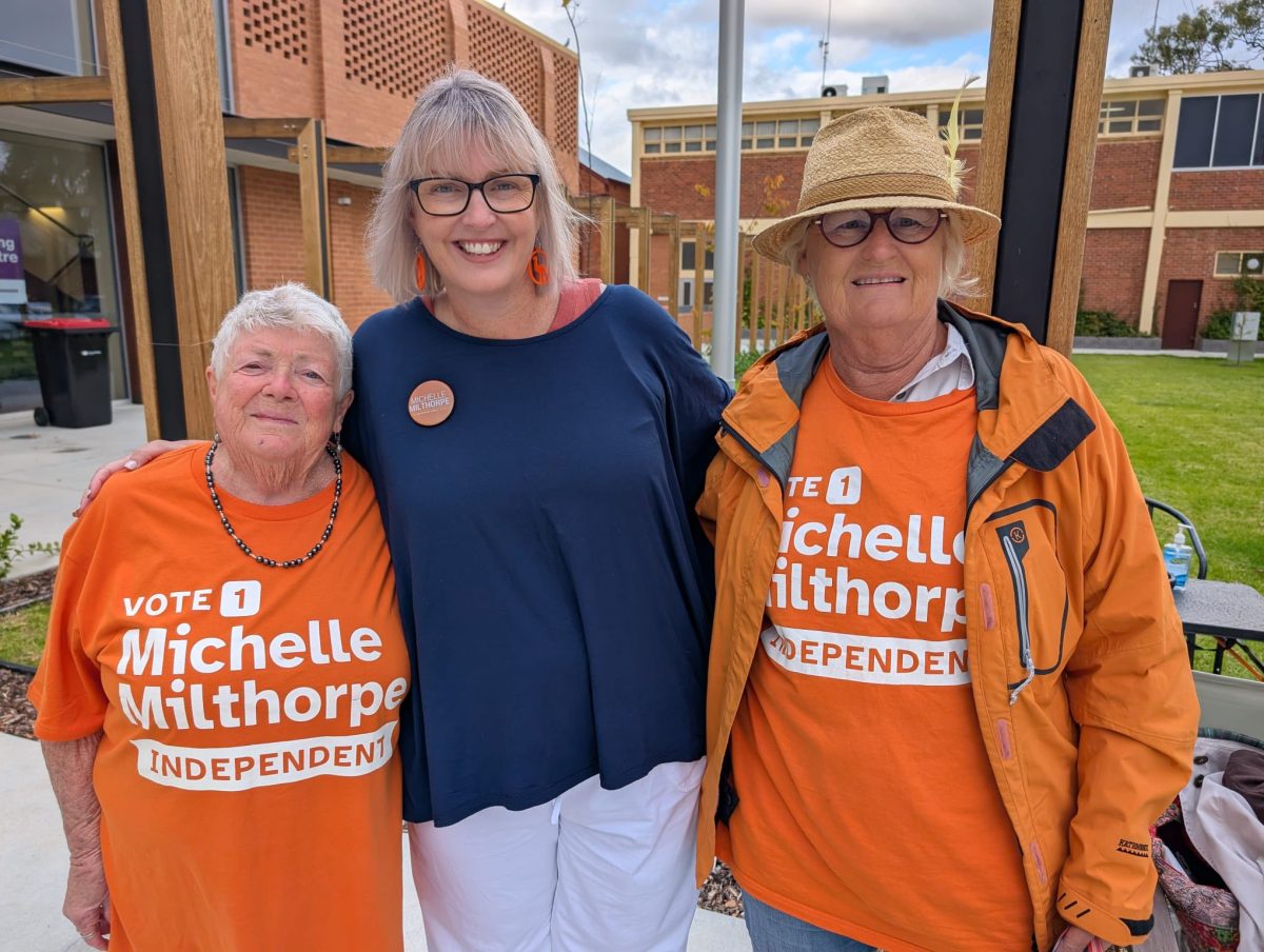 political candidate with two campaign volunteers