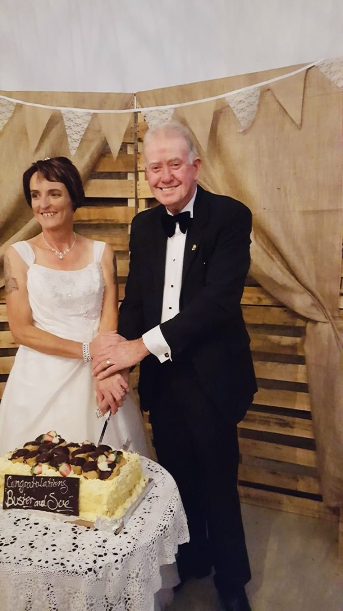 bride and groom with wedding cake