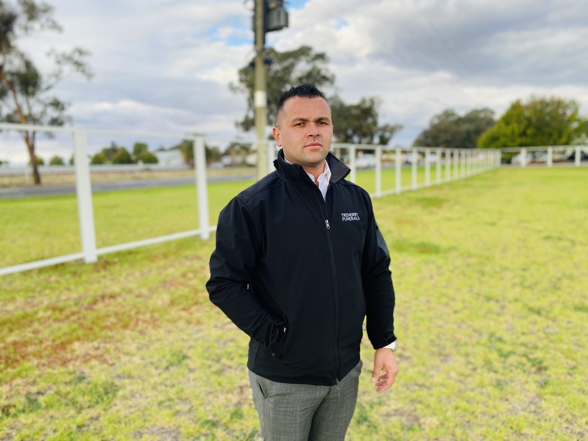 Man in front of fence 
