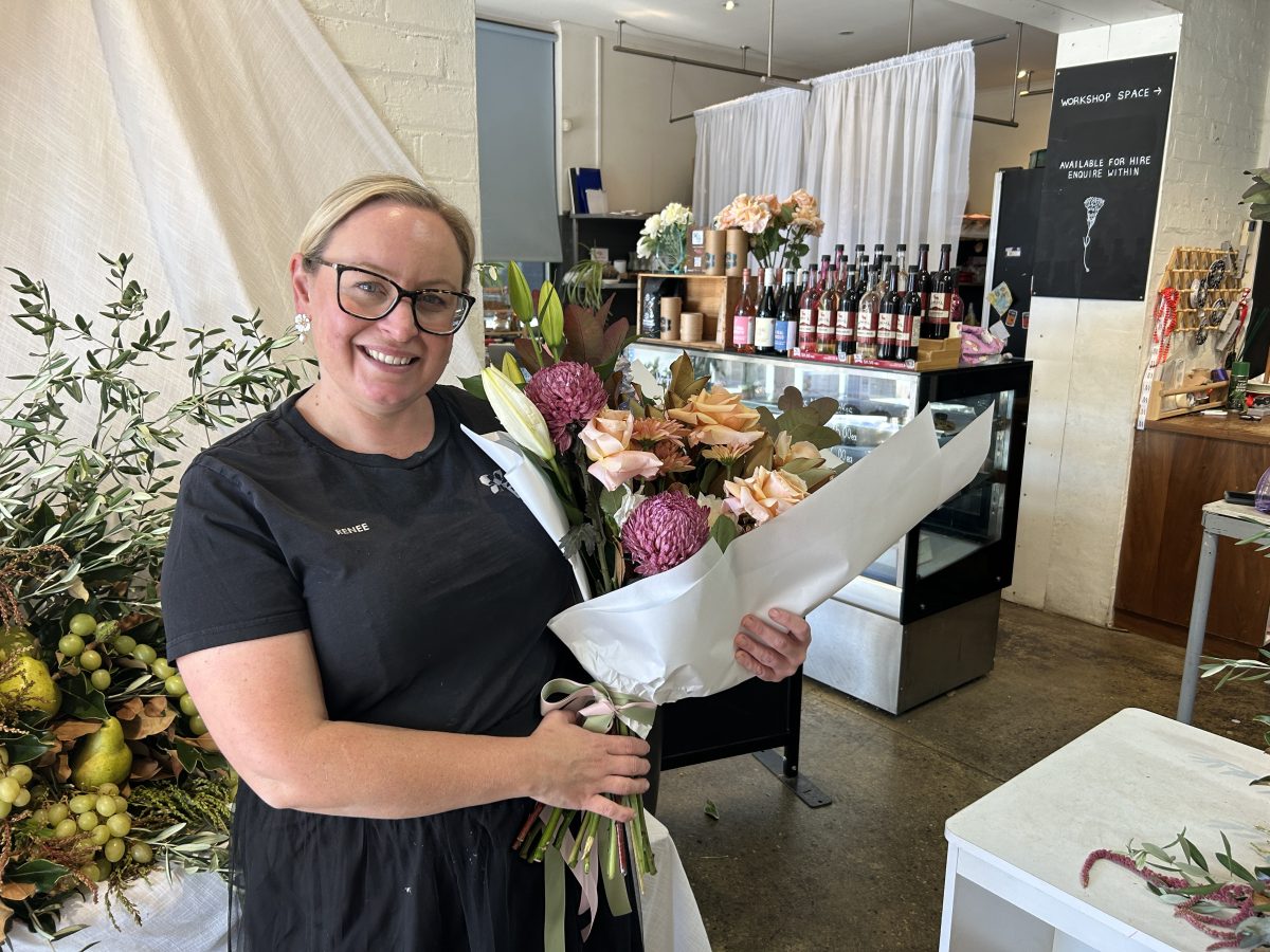 Female florist holding bunch of flowers