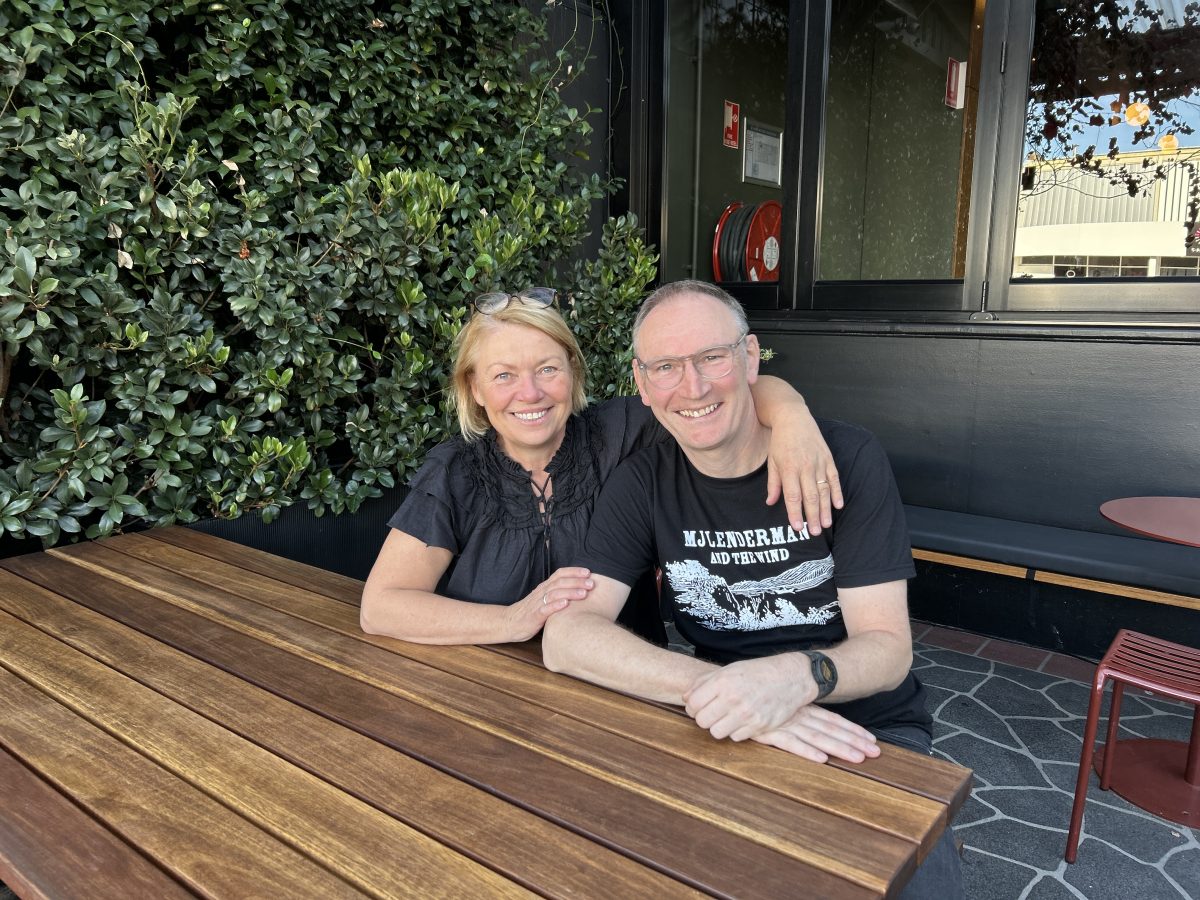 Man and woman sit at table