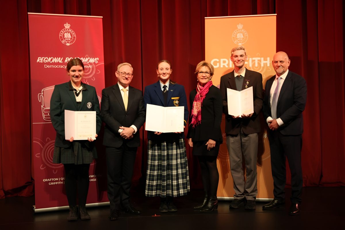 group of people on stage with awards