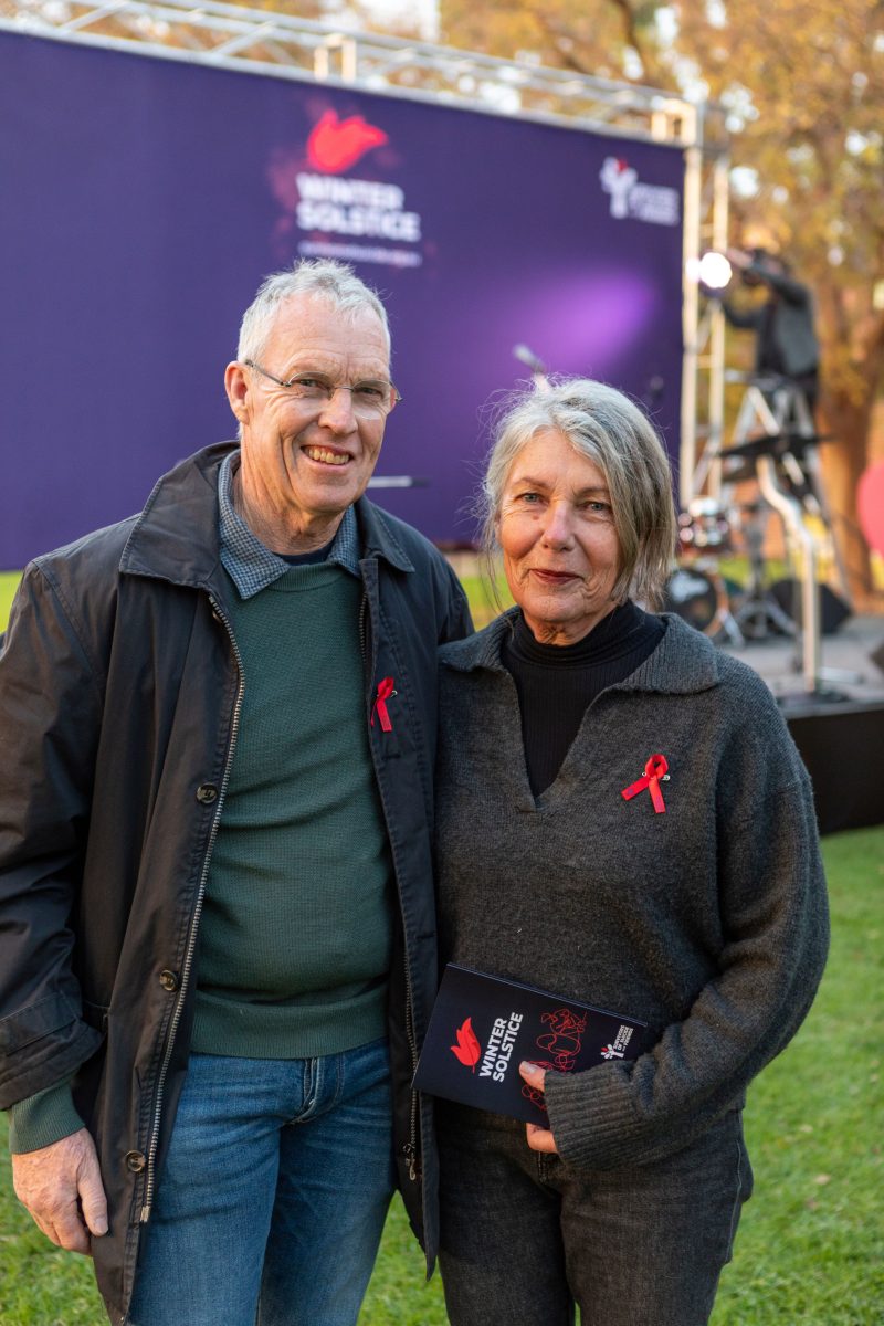 a man and a woman in front of a stage