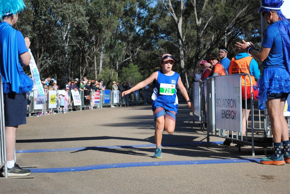 boy crossing the finishing line in a run