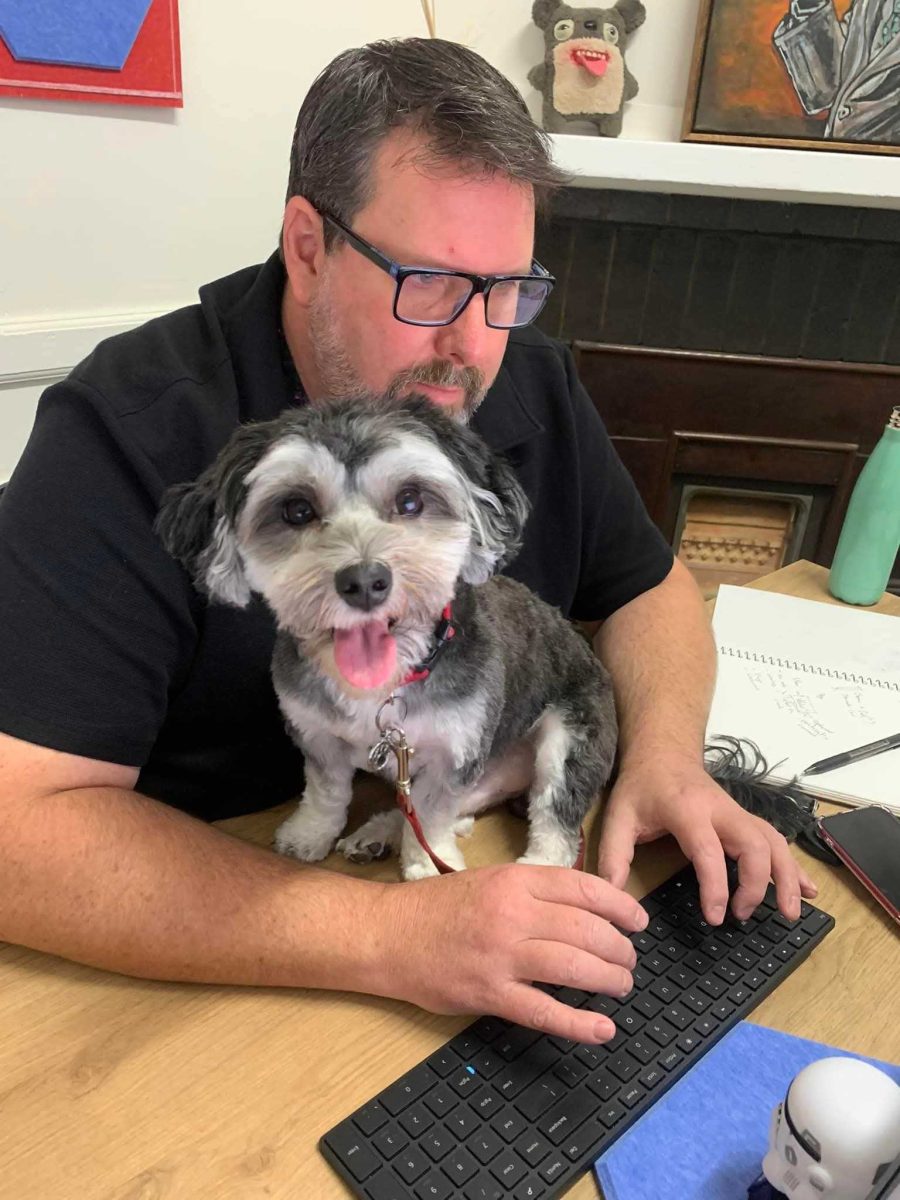 a man with his dog on his desk
