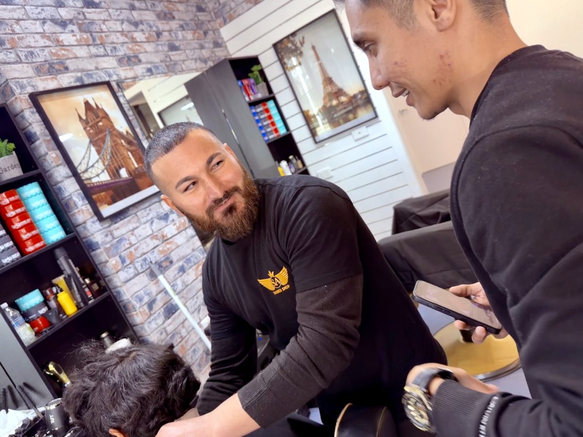 Customer Shokrollah Abbasi with S&A Barber Sam Huseyan. Picture: Marguerite McKinnon