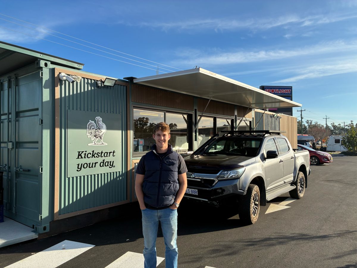 a young man outside a drive-thru coffee shop