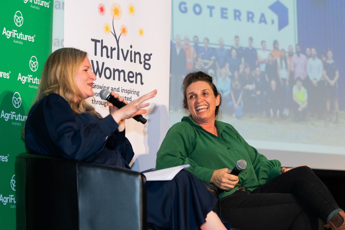 two women on stage with microphones