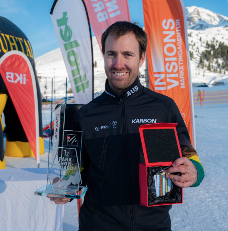 Aaron McCarthy holding awards