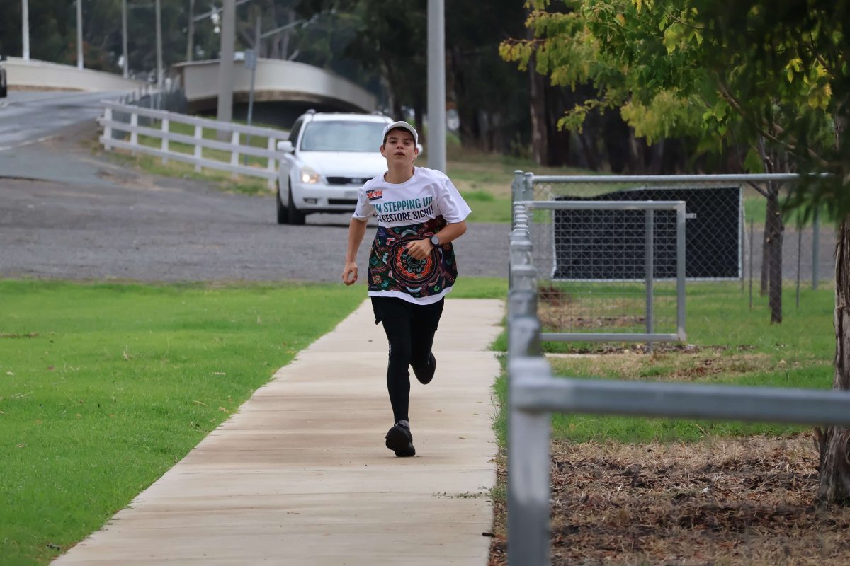 boy running along a footpath