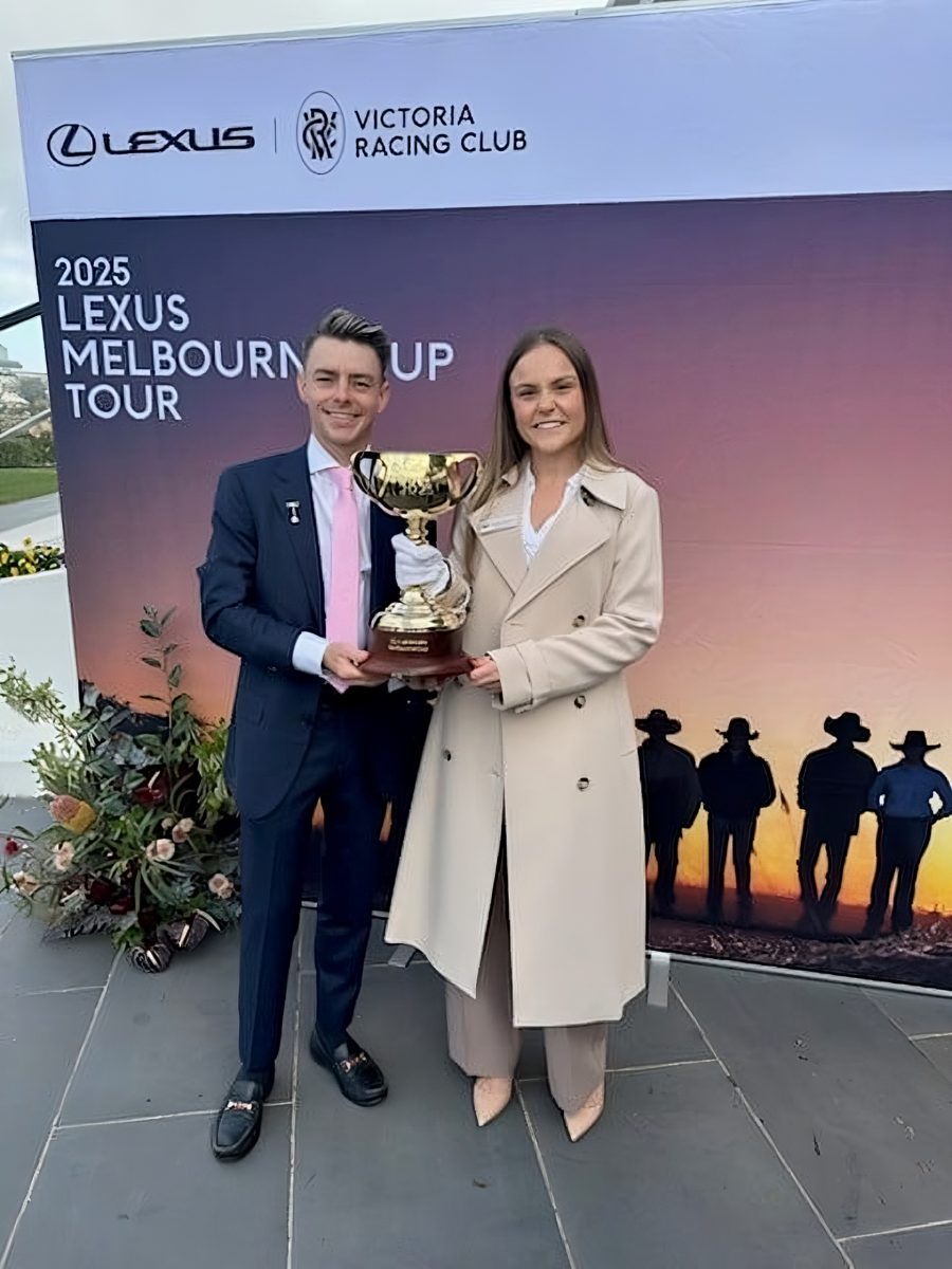 two people with a cup trophy