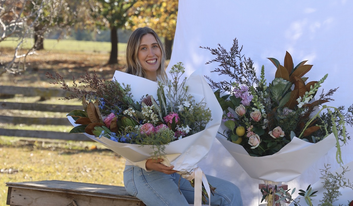 Young woman with bunches of flowers.