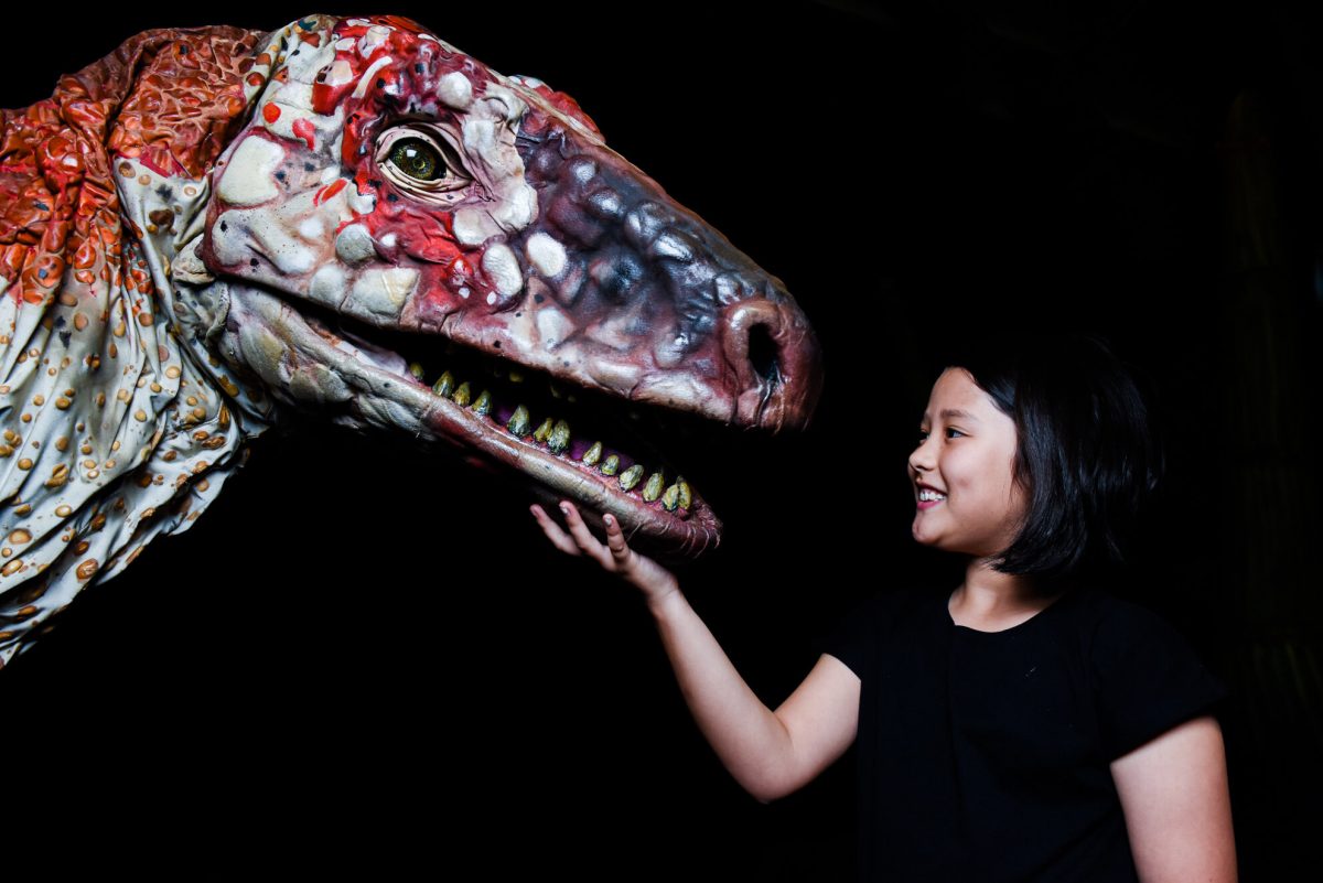 girl with a model of a dinosaur