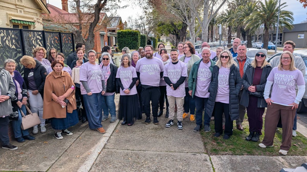 A sizable crowd gathers outside the Wagga Women's Health Centre to protest the recent $600,000 funding cut to the centre.