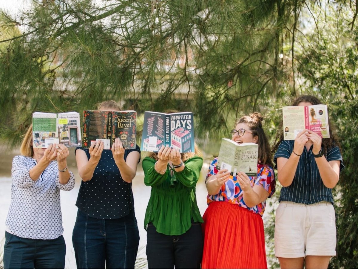 women holding opened books