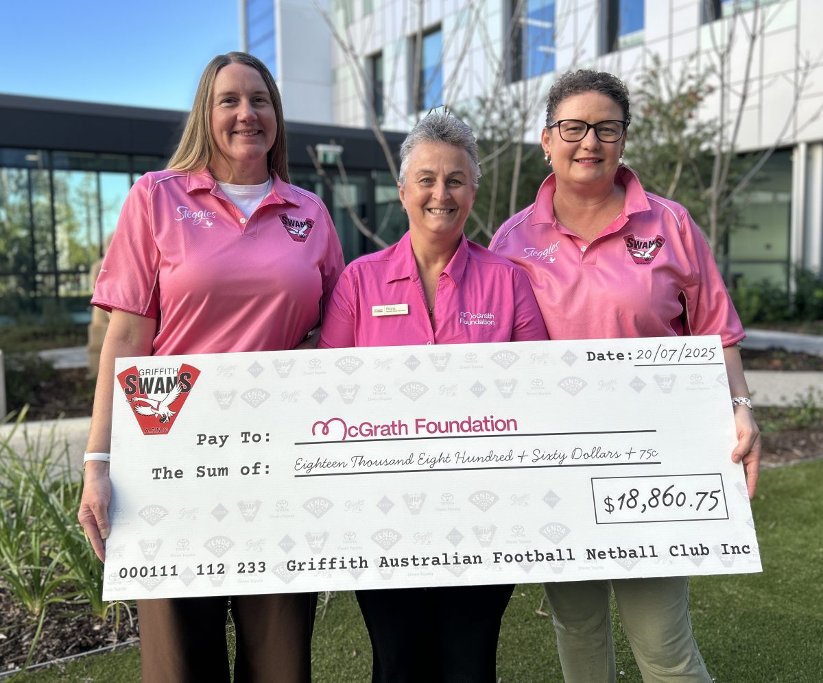 Three women in pink with cheque 