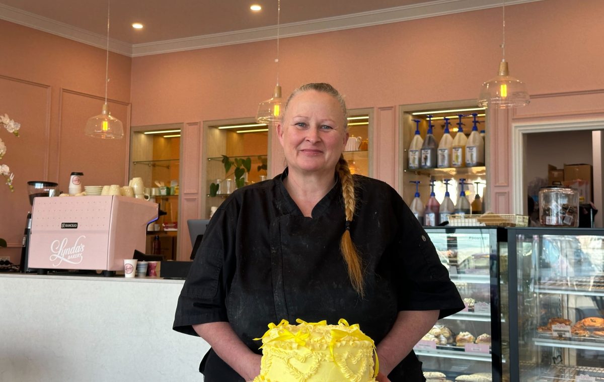 woman with a decorated cake in a bakery