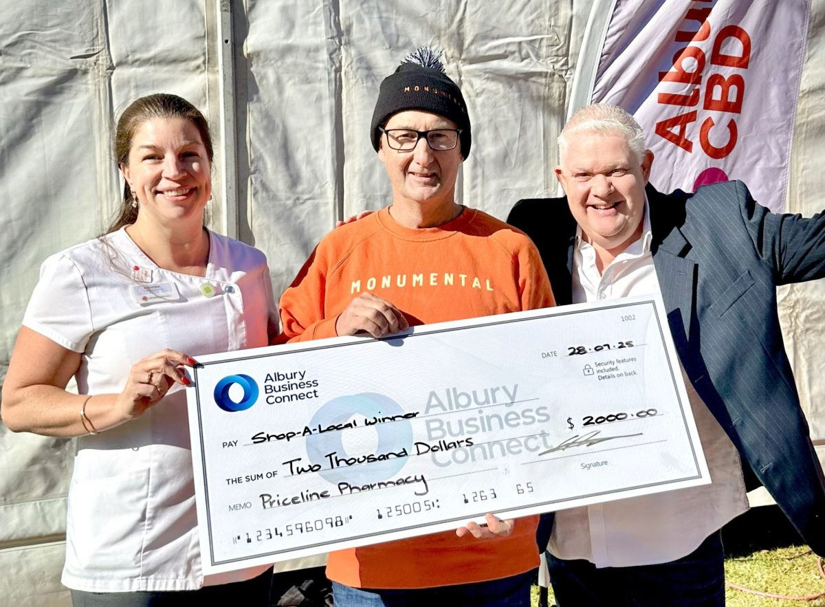 Monumental Ice Creamery's Matt Vogel (centre) receives his prize money from Priceline Pharmacy Albury's Amanda Ward (left) and Albury Business Connect's Glen Robinson (right).