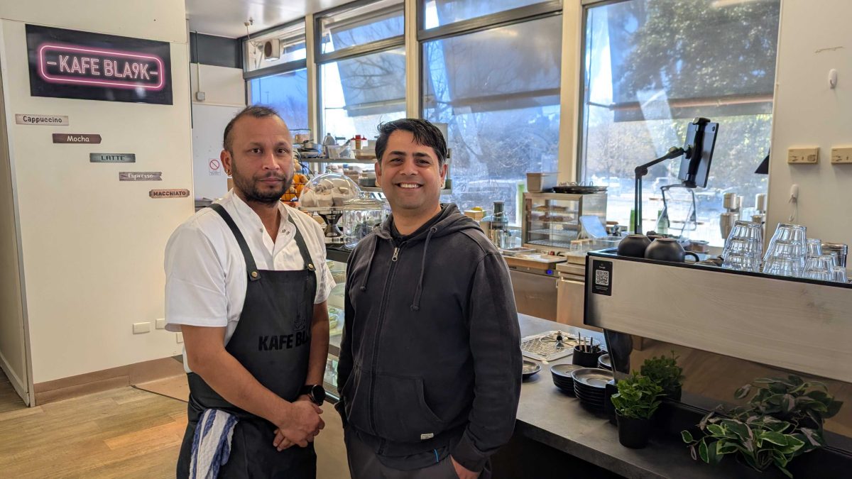 two men inside their cafe