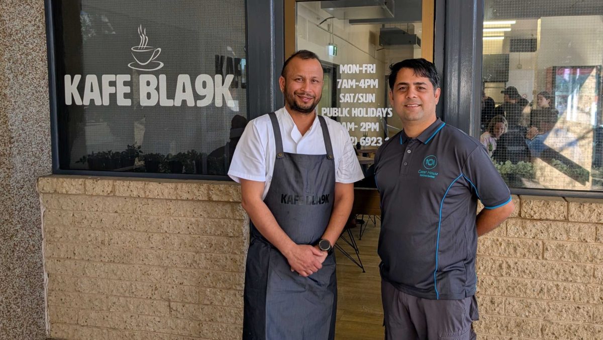 two men outside their cafe