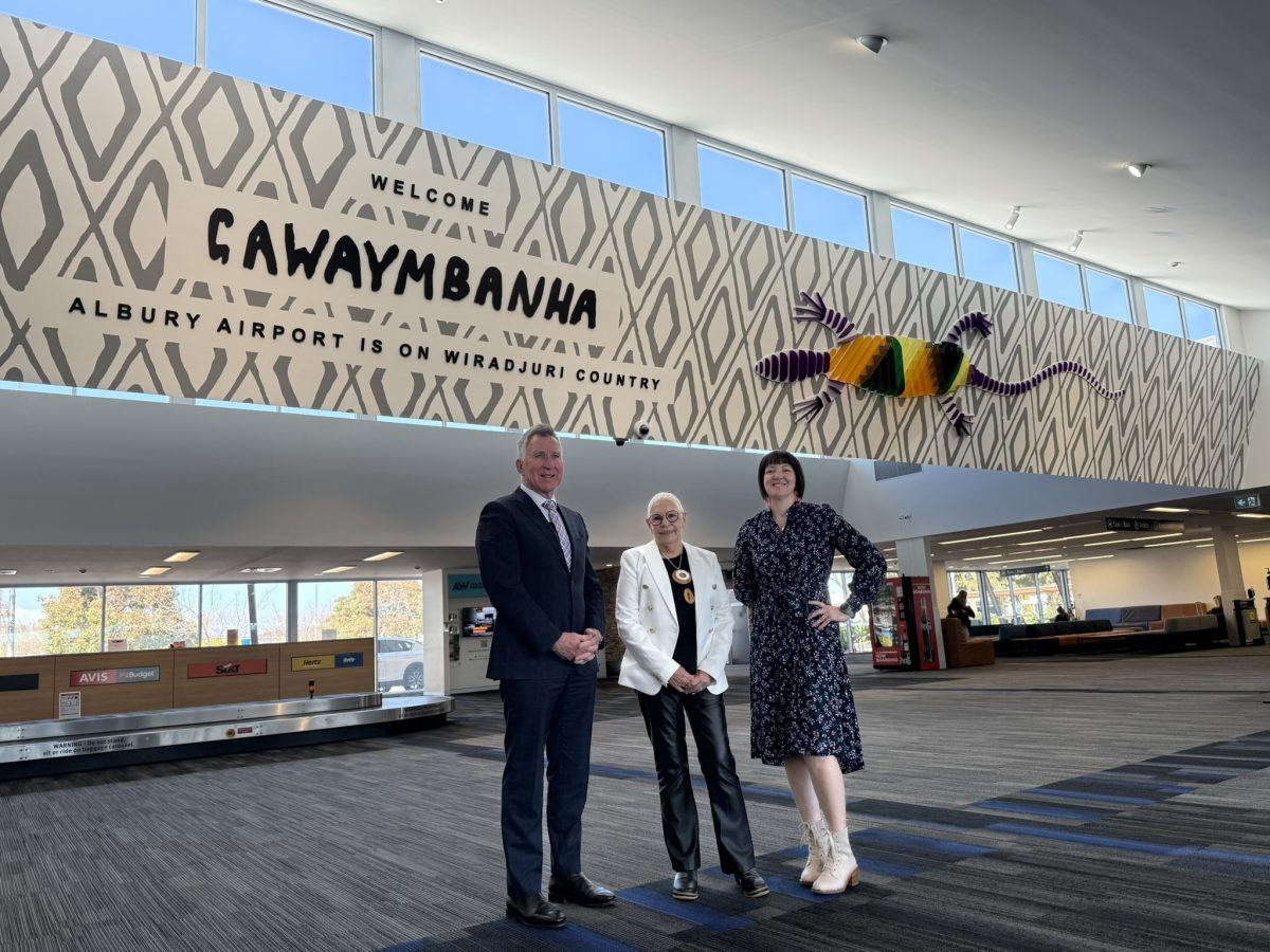 Albury Mayor Kevin Mack with Wiradjuri/Taungurung/Yorta Yorta artist Glennys Briggs and Albury council's team leader for cultural activation Karyn Ford at the official unveiling of the new artwork at Albury Airport.