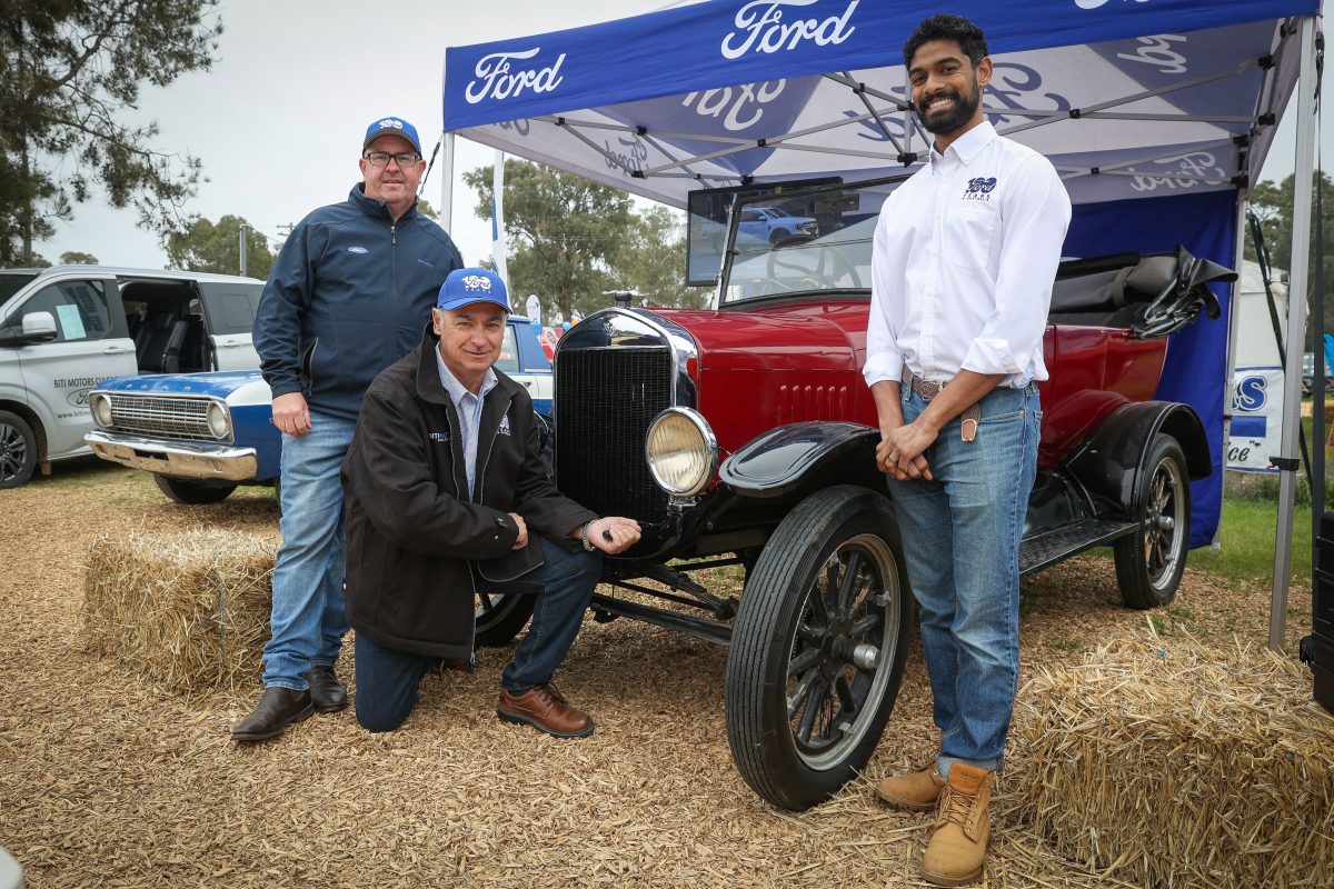 Des Royal and Paul Biti, from Culcairn's Biti Motors, with Stefan Kanaganayagam, representing Ford, and the Biti family's own 1927 Model T Ford on display at this year's Henty Machinery Field Days to help celebrate Ford's 100th anniversary.