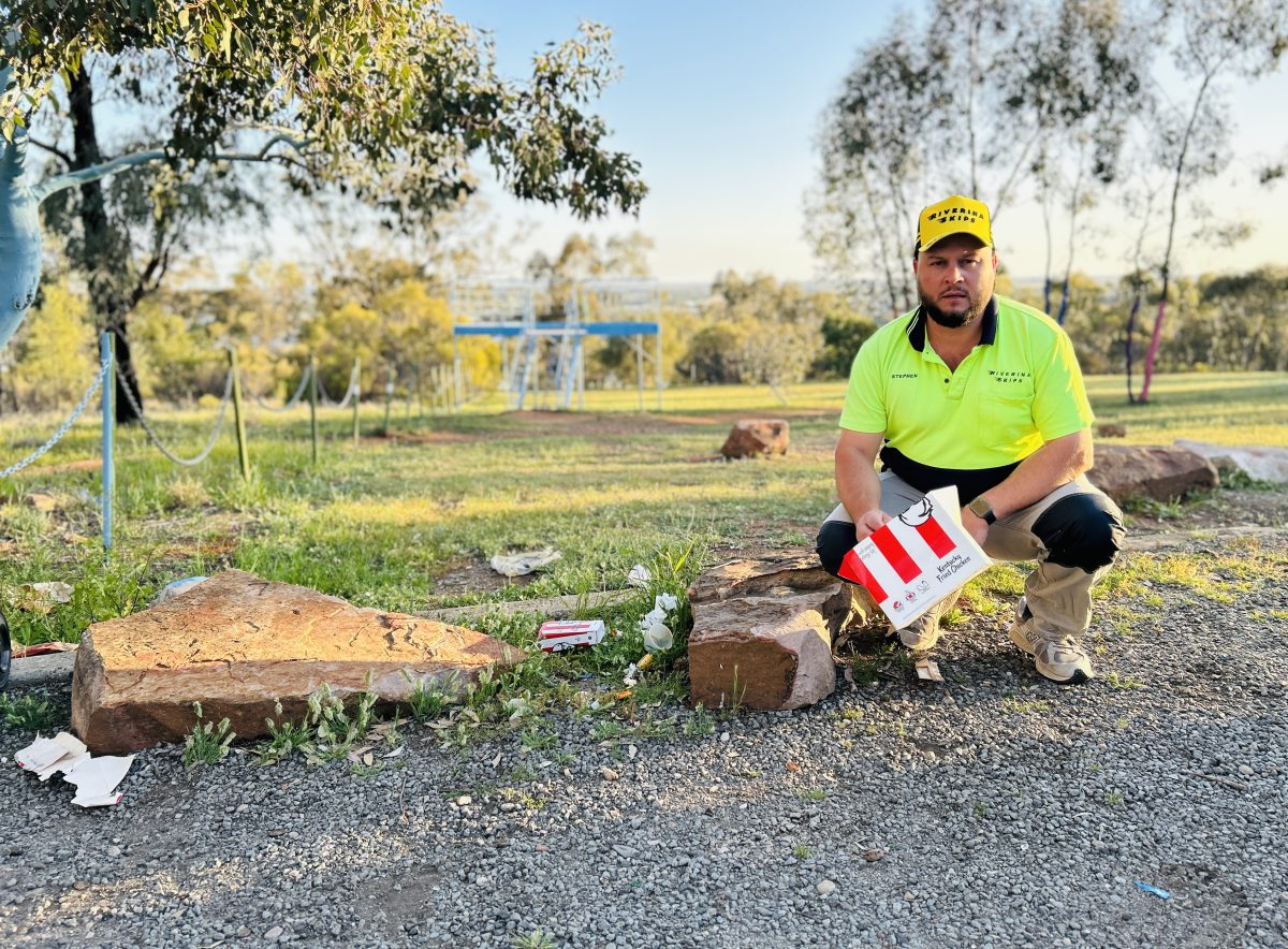 Guy on hill with rubbish 