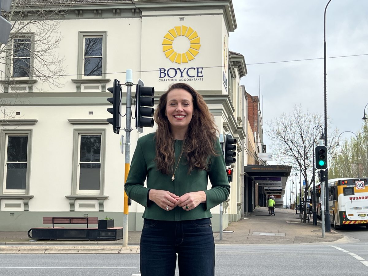 woman standing in front of a refurbished old building