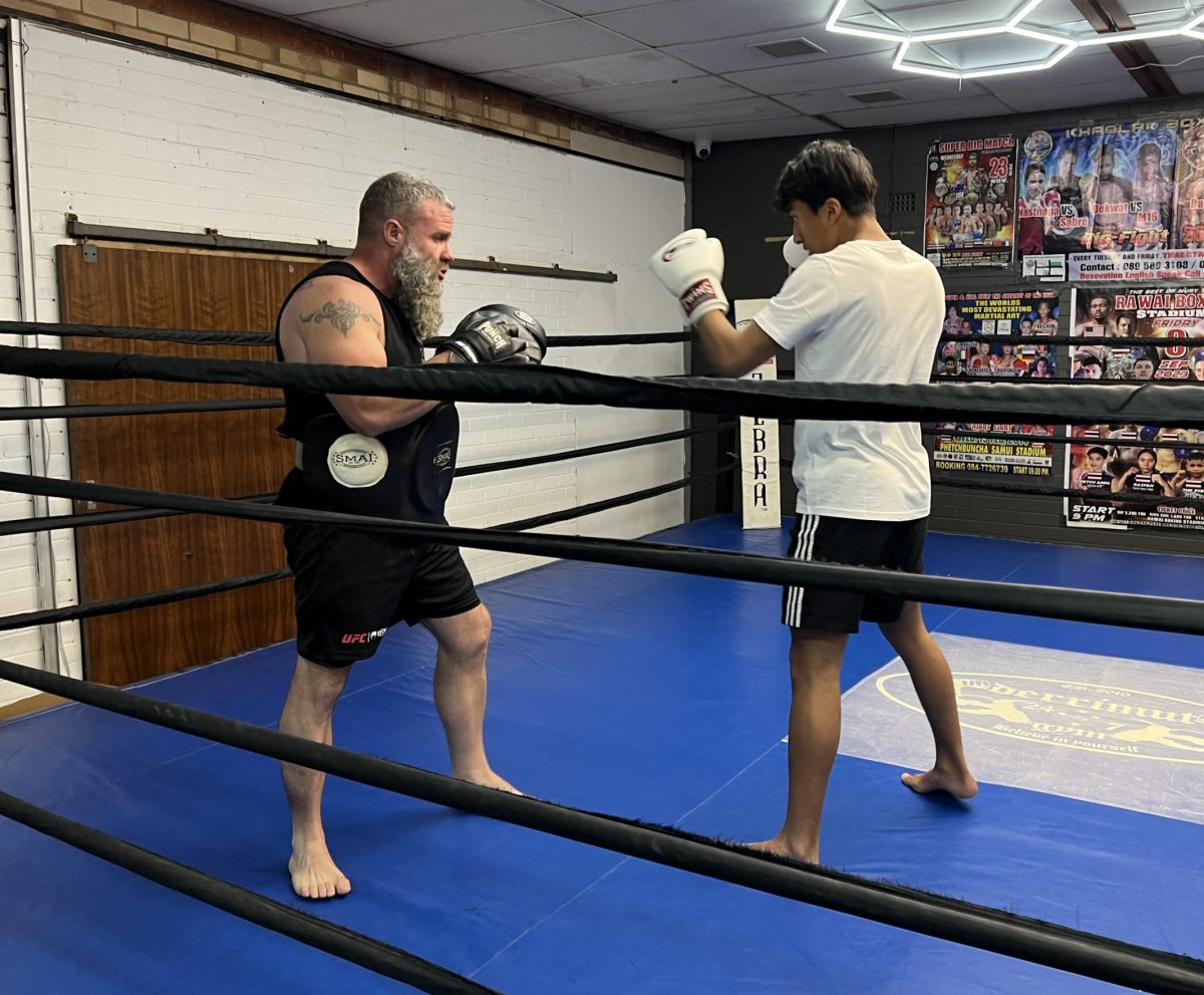Ash Fewson in a one-on-one boxing class with a young student.