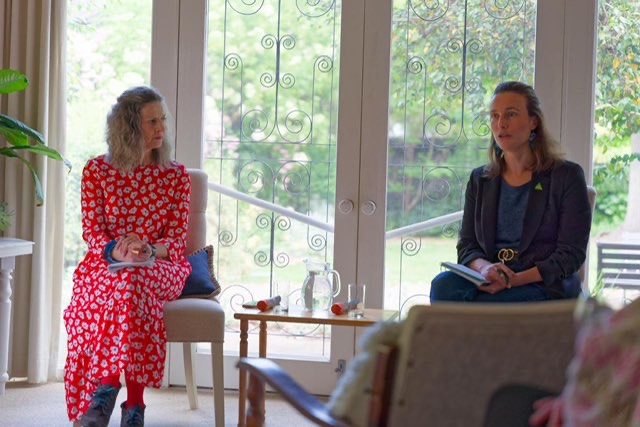 two women at a public forum