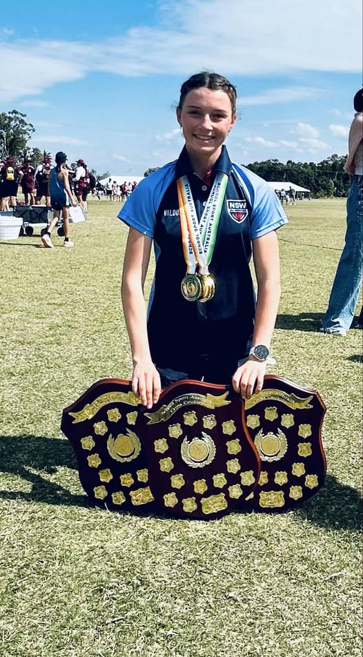 teenage girl with medals and shield