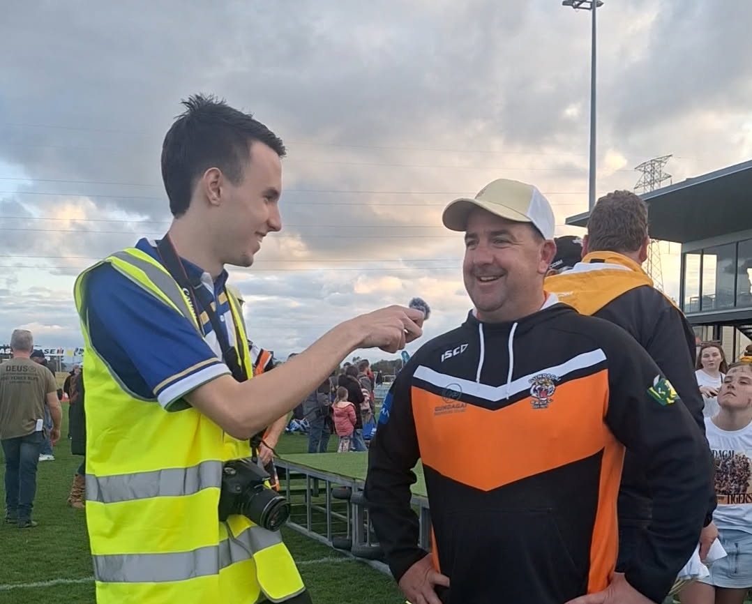 reporter with footy player