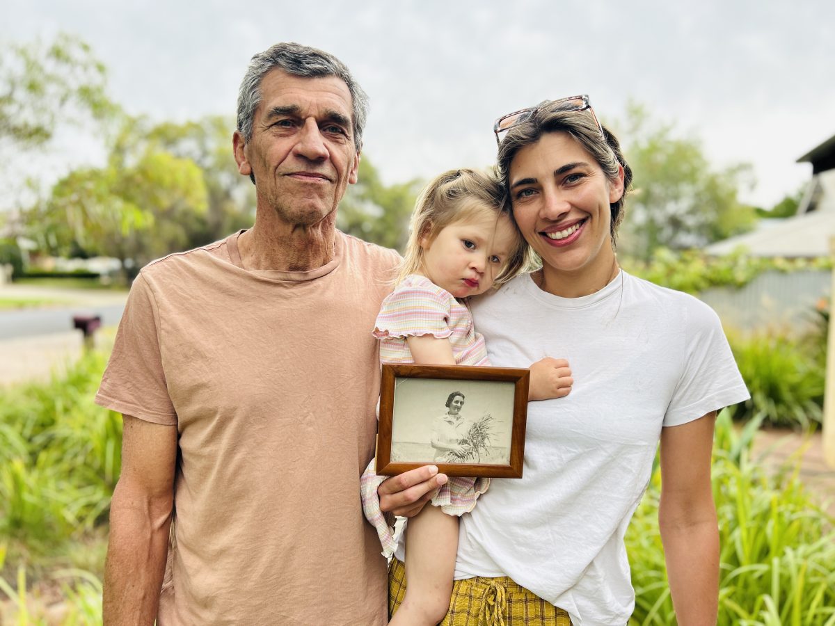 three generations of a family with a photo