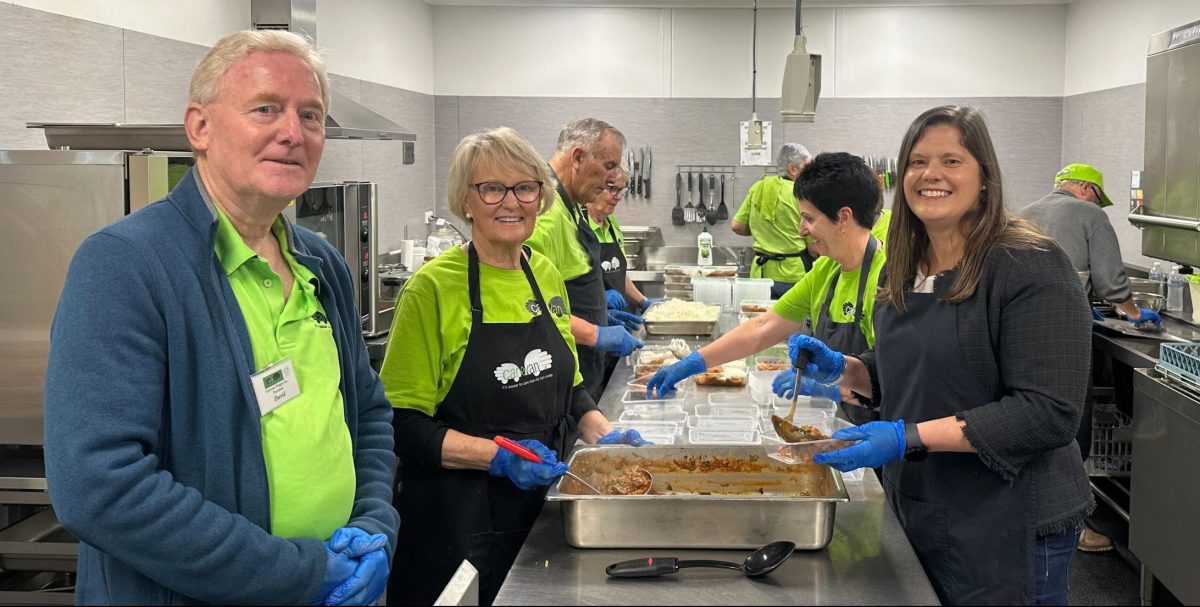 Carevan Wagga President David Brennan and Albury-Wodonga Regional Foodshare CEO Katrina Pawley with the Carevan volunteers who make more than 600 meals weekly.