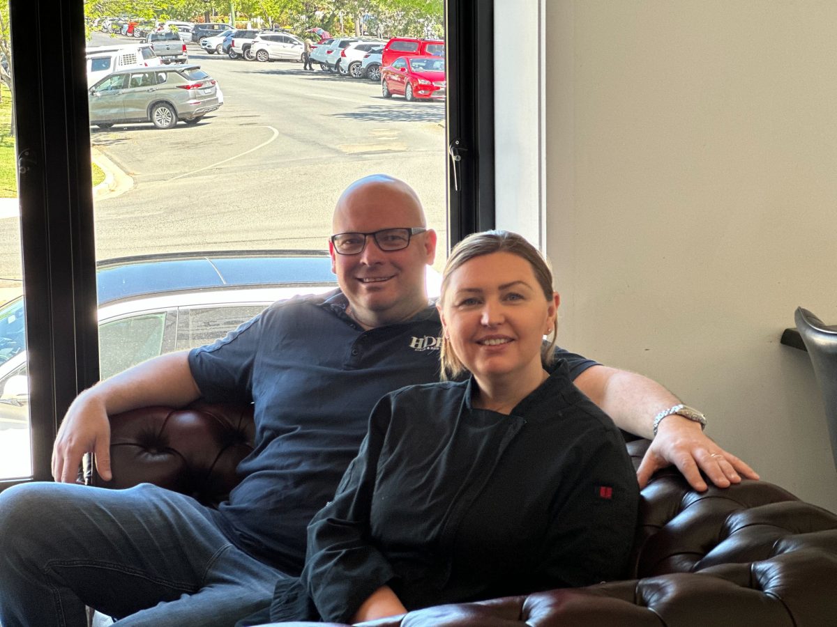 a man and a woman sitting on a leather sofa