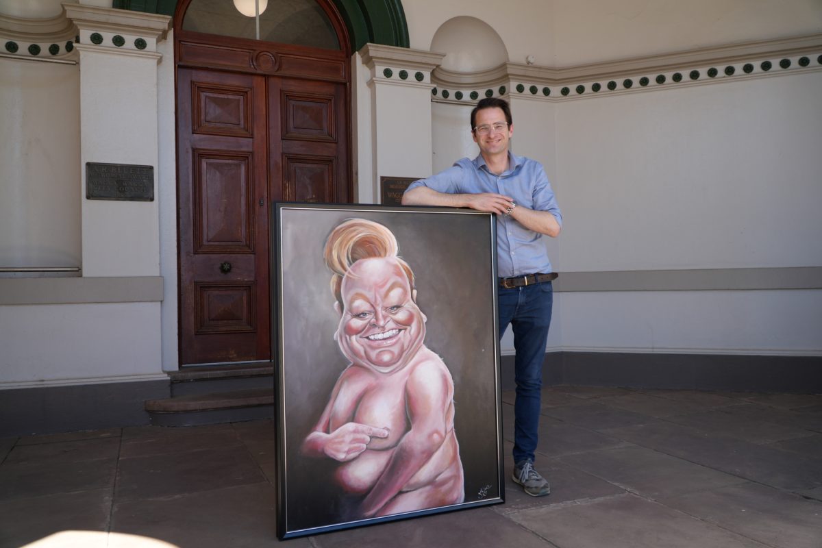 Museum of the Riverina manager Tim Kurylowicz with the 2010 Bald Archy Prize winner, <em>Patti’s Cake</em> by Judy Nadin. 