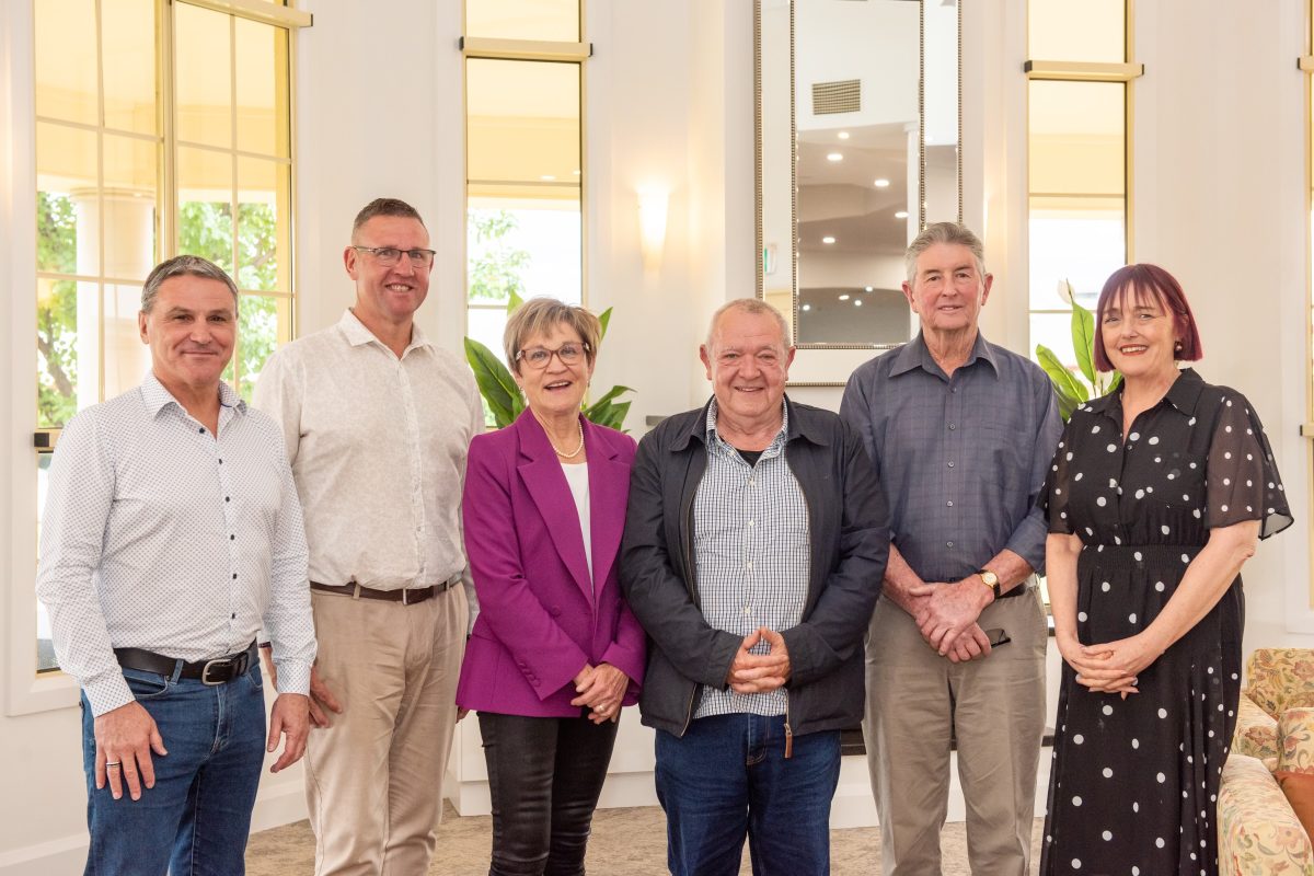 six people standing in a row