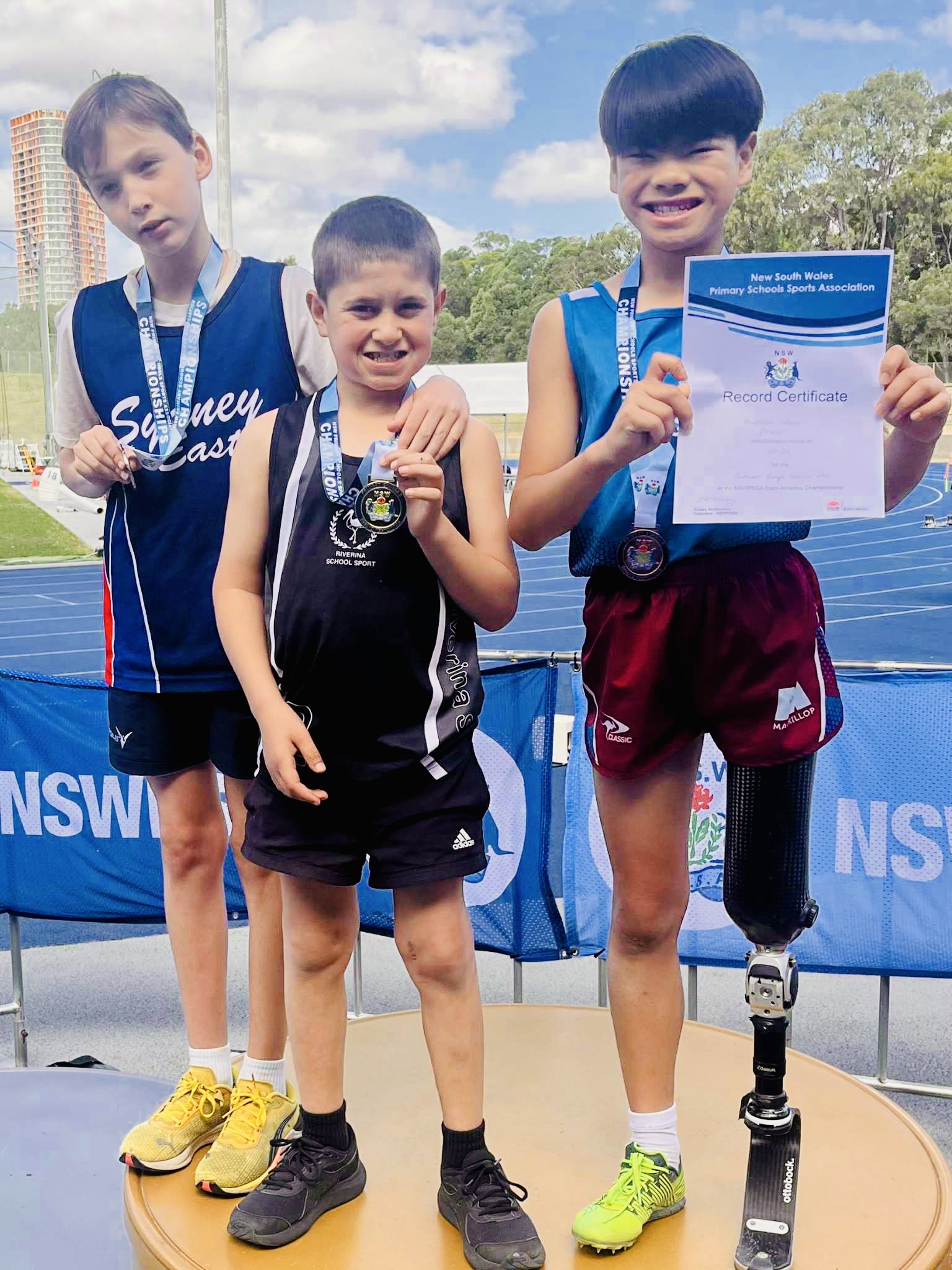 Gold medallist Cody Wheeler, 11, with silver and bronze winners on the dais at Sydney Olympic Park. Picture: supplied.