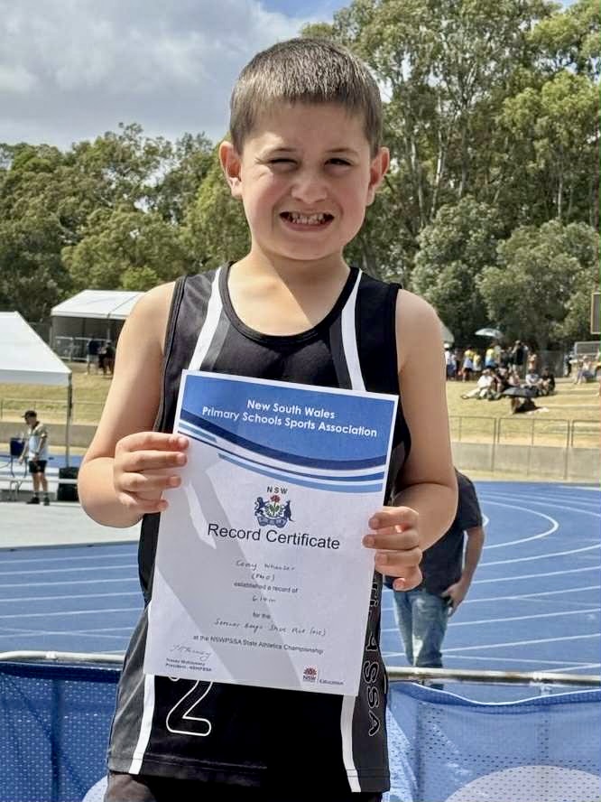 Cody Wheeler, 11, with one of his certificates for setting a new state record at this year’s primary school athletic championships in Sydney. Picture supplied.
