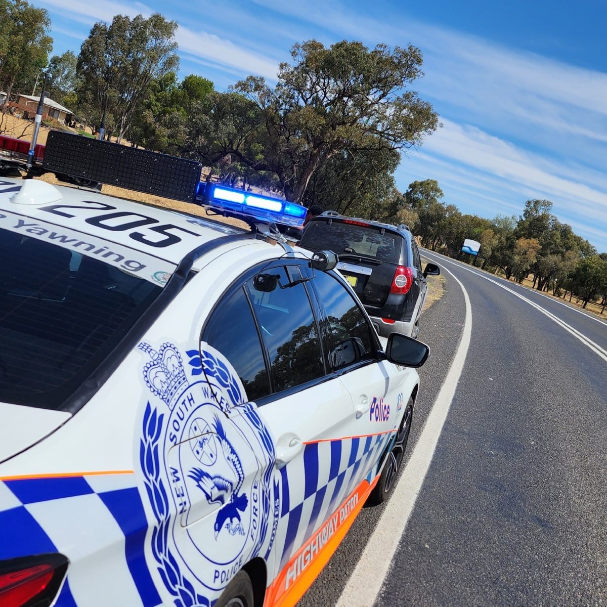 Police car stops vehicle 