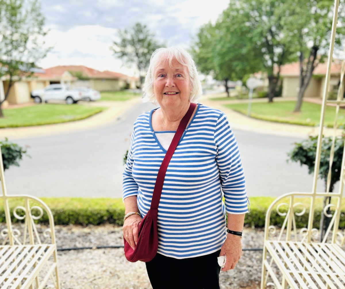a woman standing outside a house