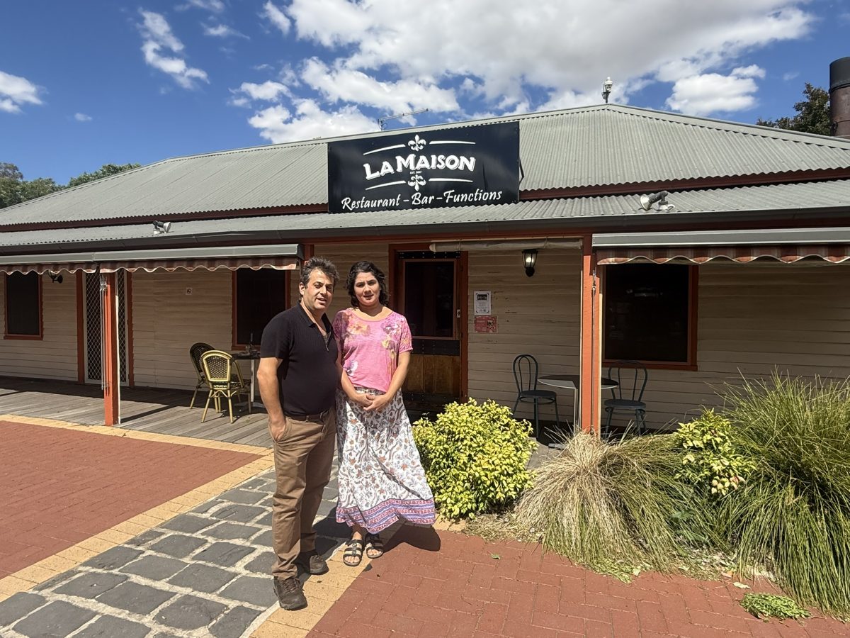 Man and wife standing in front of restaurant