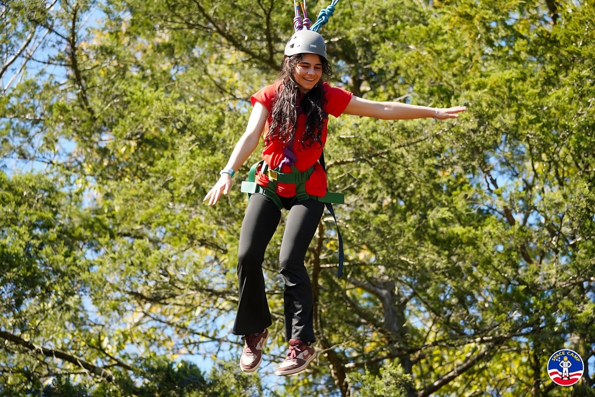 girl being suspended midair to simulate space walking