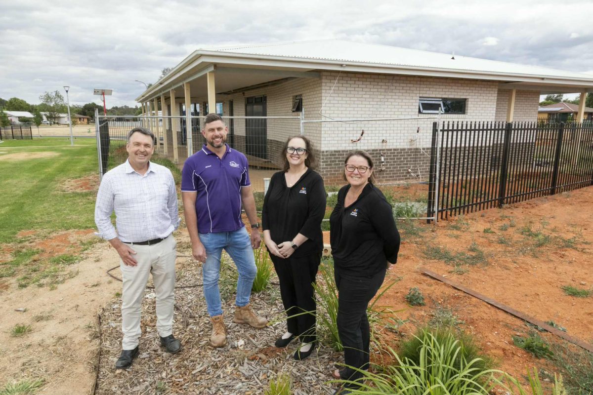 Four people outside building
