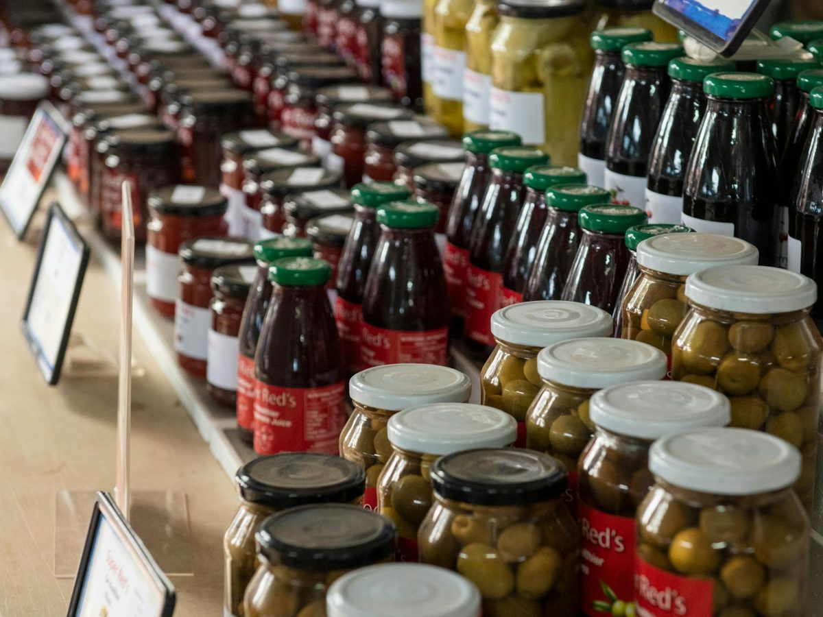jars of olives and other produce on display