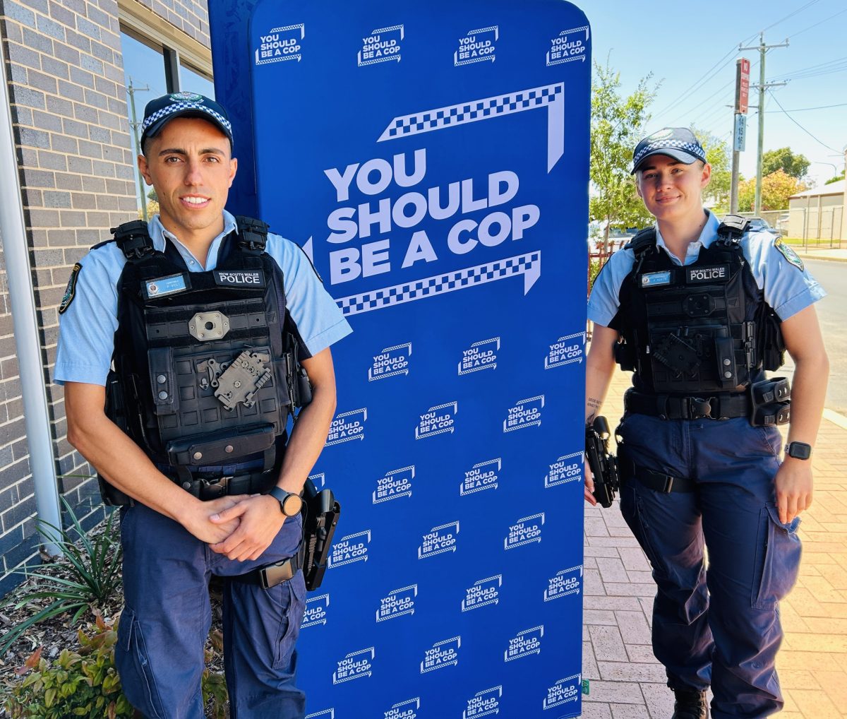 two police officers next to banner
