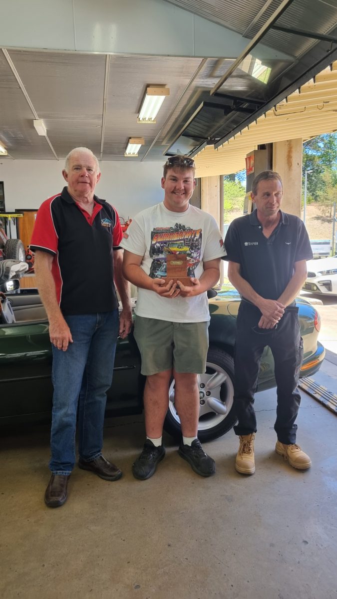 Student with teacher and donor and car