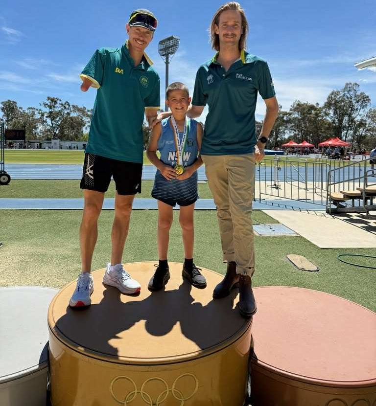 Cody Wheeler congratulated by Australian Paralympian Michael Roeger and Australian Athletics and Triathlon Paralympian Sam Harding.