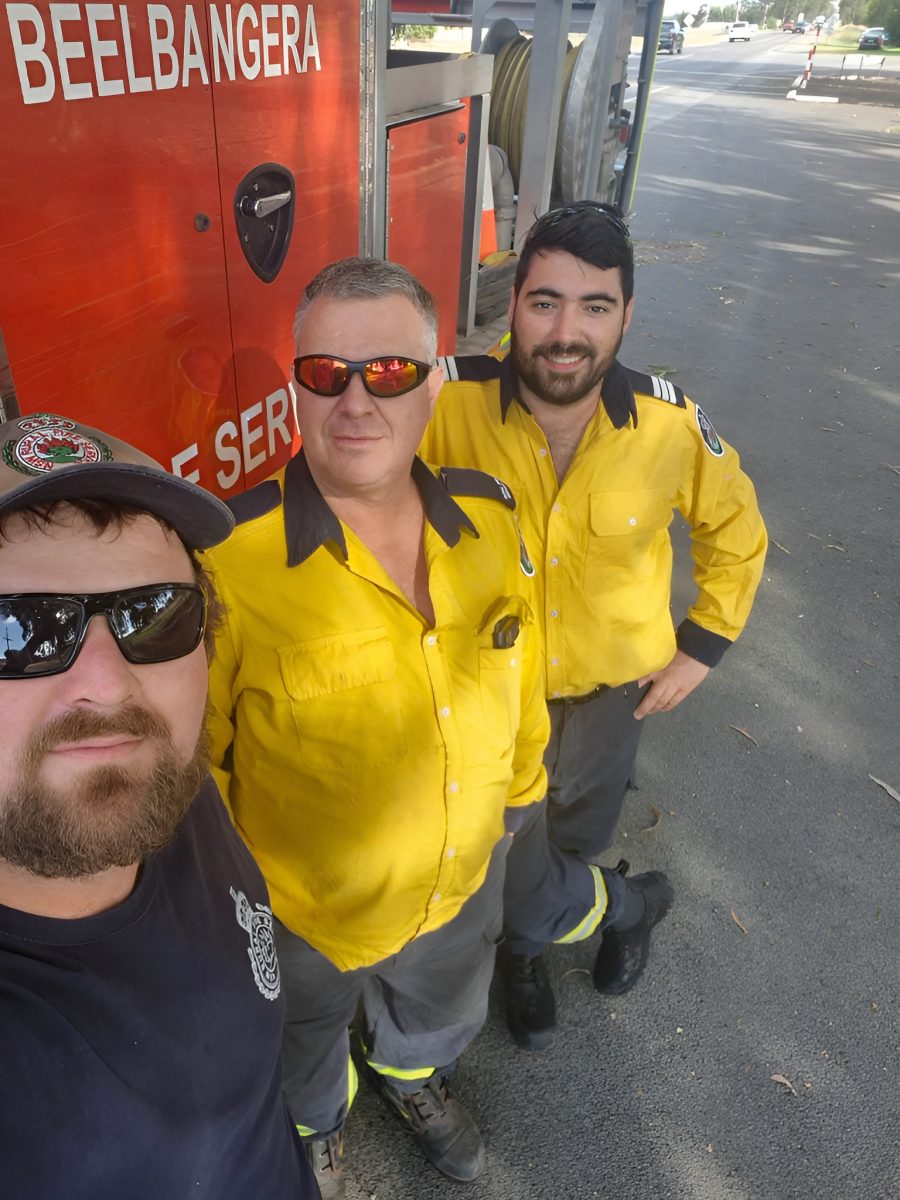 three guys outside fire truck